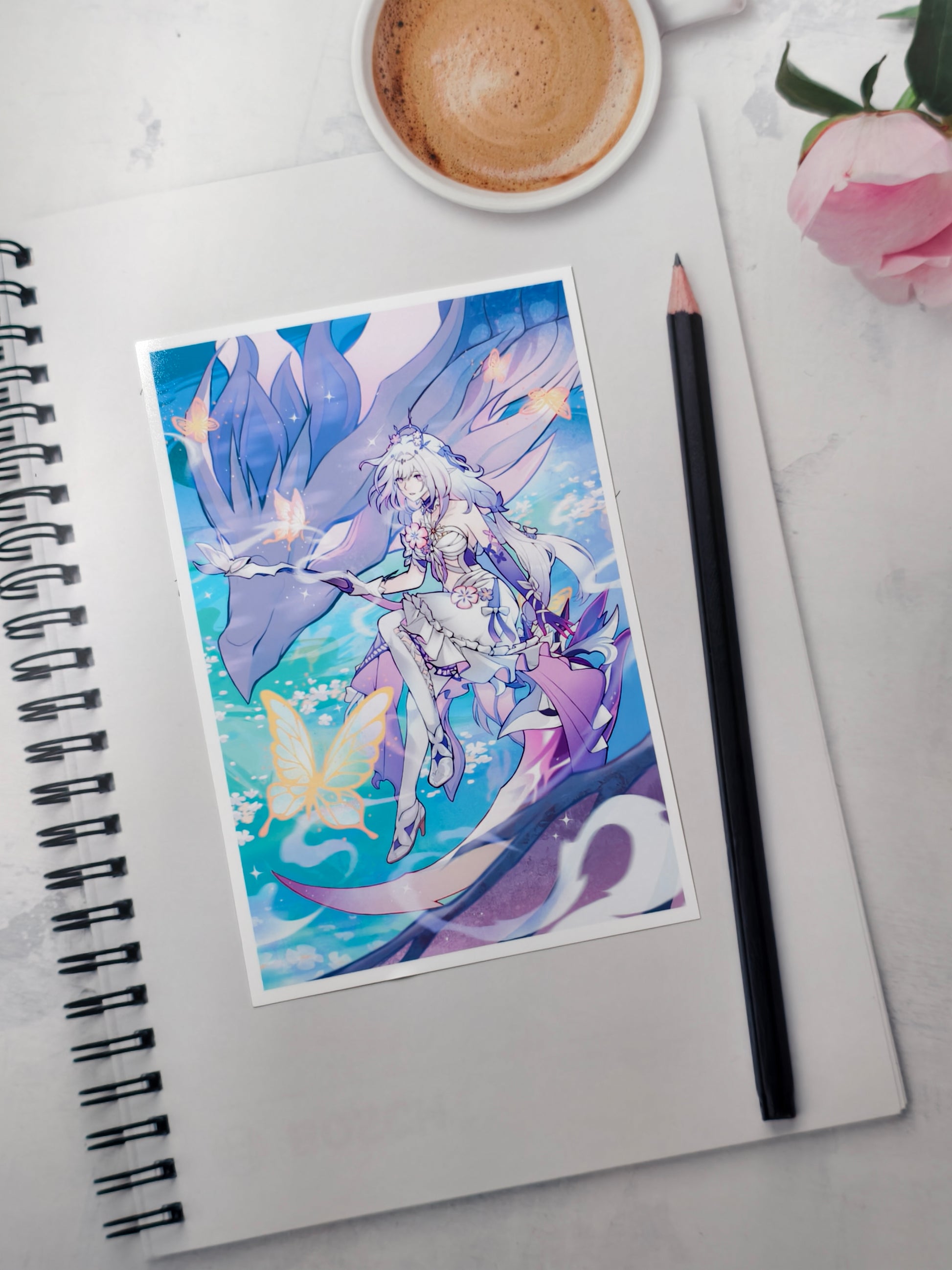 Castorice Honkai Star Rail anime art print on a white spiral notebook next to a pencil and coffee cup.