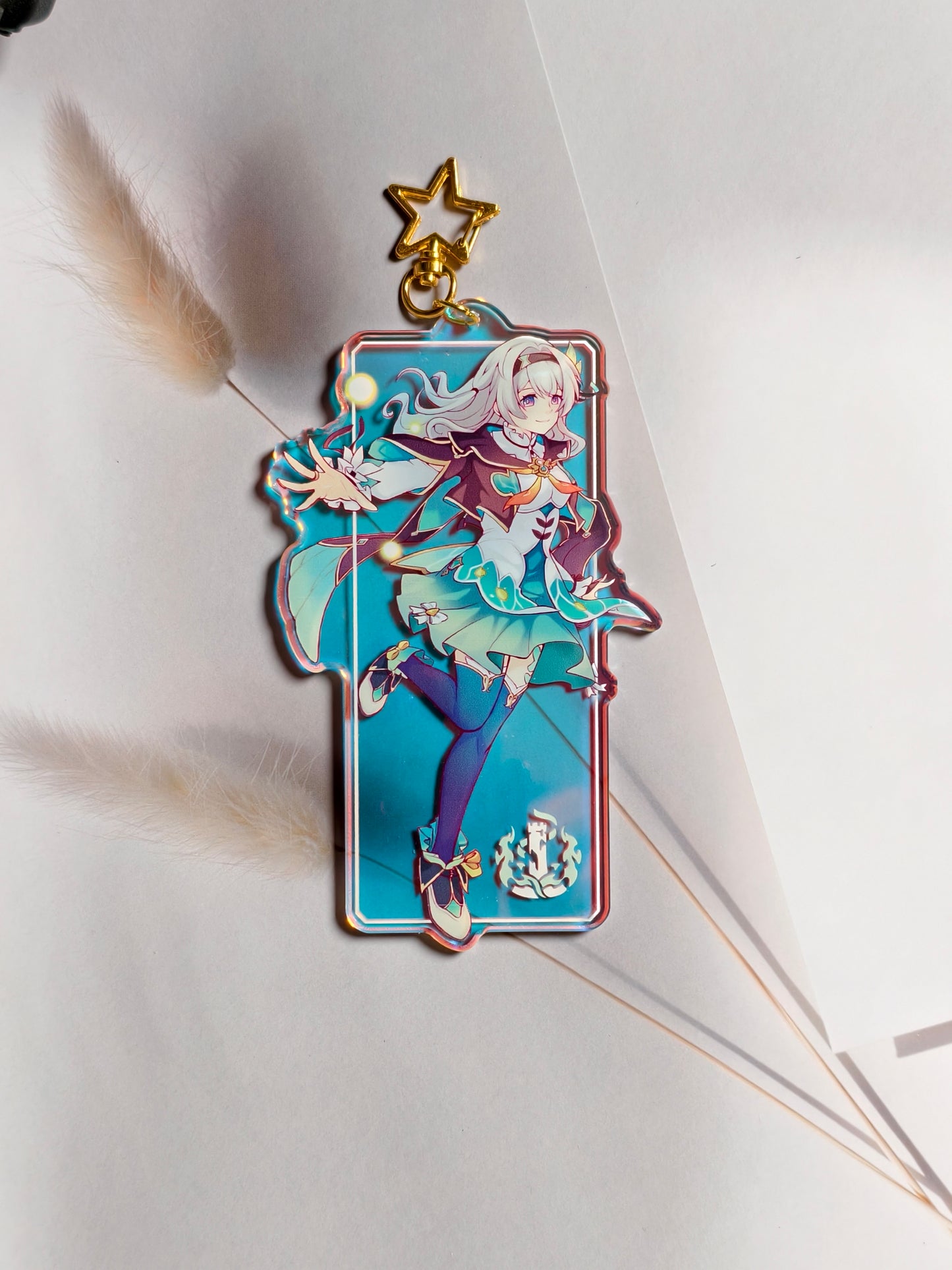 Firefly from Honkai Star Rail rainbow holographic acrylic bag charm styled with gold star clasp.